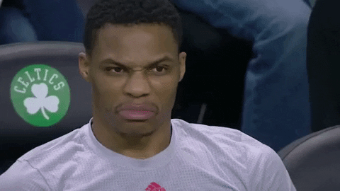 Sports gif. Russell Westbrook looks around with a very disapproving frown.
