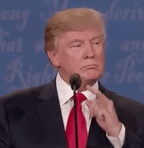 Political gif. Donald Trump, during a debate, stands at a podium and runs his pointer finger across his top lip and scratches next to his nose.