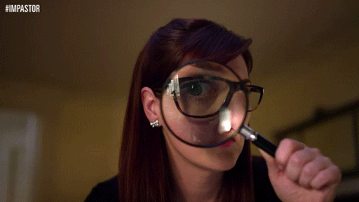 Person looking with magnifying glasses