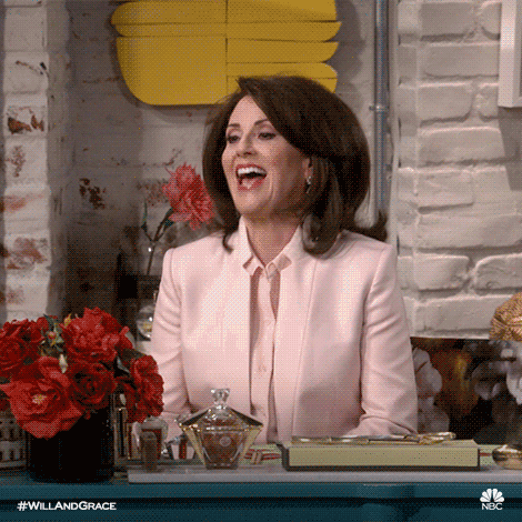 TV gif. Megan Mullally as Karen on Will and Grace Revival bouncing eagerly and clapping her hands.