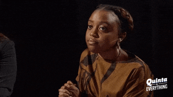 Celebrity gif. A speechless Quinta Brunson Folds her hands and purses her lips.