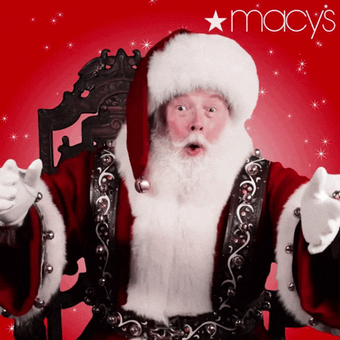 Video gif A man playing Santa sits on a throne his arms outstretched towards us and says Merry Christmas before laughing his signature ho ho ho