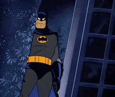 Cartoon gif. Batman from Batman: The Animated Series stands in the corner of a cave and stares down at us. He gives us a thumbs up, never changing expressions during it.