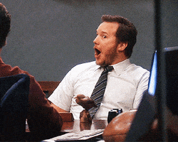 Parks and Recreation gif. Chris Pratt as Andy lights up in excited surprise as he reacts to shocking news with his mouth agape.