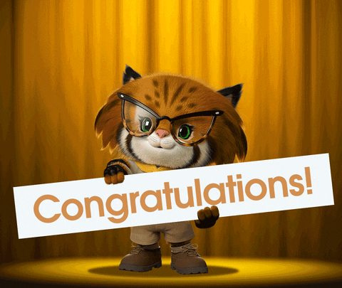 Pohyblivá animace s kočičkou v brýlích, držící nápis "Congratulations!" s objevujícími se zlatými balónky.