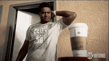 TV gif. Pooch Hall as Daryll on Ray Donovan. He's just woken up and is rubbing his head when he spots a coffee cup on the table. He picks it up and sees the word, "Sorry," written on top.