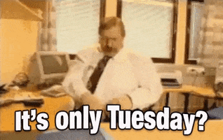 Video gif. A blurry video shows a man in a cubicle sitting in front of a 90s-style computer throwing his papers all around the room in disgust. Text, "It's only Tuesday?"