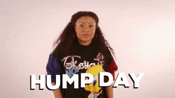Celebrity gif. Shalita Grant dramatically swings her shoulder forward and hunches over. Text, "Hump Day."
