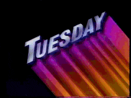 Text gif. Metallic purple title reading, "Tuesday" sits slanted while gradient magenta to orange streaks add colorful dimensionality to the text. Flashing bars going from light pink to purple pass through to further illuminate the word.