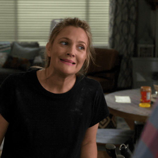 TV gif. Drew Barrymore as Sheila in Santa Clarita Diet. She smirks, shakes her head, and mouths the word as it appears, "Oopsie."