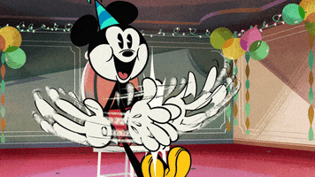 Disney gif. Mickey Mouse, wearing a birthday hat, his head like a balloon, claps emphatically, eternally, for us.
