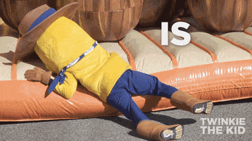 Video gif. A corn cob cowboy mascot rolls off of a bouncy house and onto the ground like it’s flopping down exhaustedly. Text, “Is it Friday yet?”