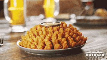 Ad gif. We see a hand reach in and take a piece of a Bloomin' Onion at Outback Steakhouse. Text, "Welcome back!"