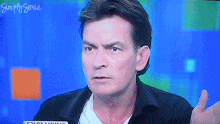 Celebrity gif. Charlie Sheen rolls his eyes and puts his hands up in a dismissive gesture as if to say, “Whatever.”
