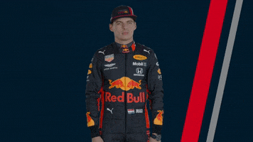 Ad gif. A man wearing a Red Bull racing uniform dabs, pointing and looking up.