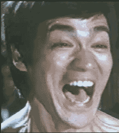 Celebrity gif. Bruce Lee has a large, over exaggerated smile that slowly disappears until he looks utterly unimpressed and a little annoyed.