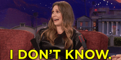 Late Night gif. Elizabeth Olsen sits on the couch on Conan. She looks out at the audience with an exaggerated worried look, shaking her head with her eyes wide, as she says, “I don’t know.”