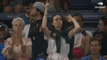 Video gif. Two women in the stands at the 2023 US Open are dancing and vibing to the music with serious expressions like they are taking their moves very seriously.