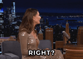 Celebrity gif. Hailey Bieber is on The Tonight Show starring Jimmy Fallon. She sits, getting interviewed by Jimmy, and she looks out to the crowd shrugging. She says, “Right?” with a big smile, hoping to find someone in the crowd who agrees. 