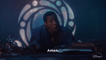 TV gif. Jonathan Majors as Kang the Conqueror pulls his hands back in a dramatic, sarcastic prayer. Text, "Amen."