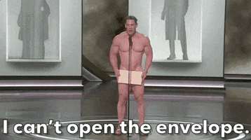 Oscars 2024 GIF. A naked John Cena has finally made it to the microphone with the Oscars envelope covering his privates. He looks frightened as he has a sudden realization that the winner is in the envelope. The envelope that holds his dignity together. He finally admits to us, "I can't open the envelope." 
