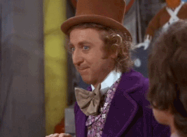 Movie gif. Gene Wilder as Willy Wonka places his arm on a wall and props his head up with his hand, pretending to be super interested. He gives a fake smile and sarcastically says “really?”