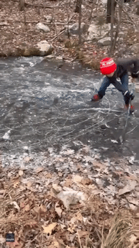 Boy Practices His Hockey Skills on Frozen Pond