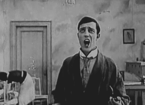 Gif of Buster Keaton pulling down a sign that says The End