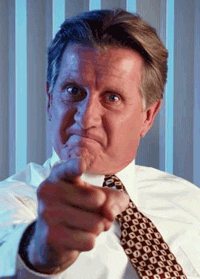 Photo gif. An angry senior man in a white shirt and tie points at us and glowers.