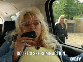 Reality TV gif. Beth Chapman on Dog The Bounty Hunter sits in the car with a flip phone held up to her mouth. She speaks into the phone. Out of the car window, we can see Duane Chapman turn and walk away. Text, "So let's see some action."