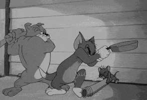 Cartoon gif. Black and white clip from Tom and Jerry in which Jerry wields a pipe toward Tom's knees while Tom comes down on Jerry with a skillet, and Spike swings at Tom with a baseball bat.