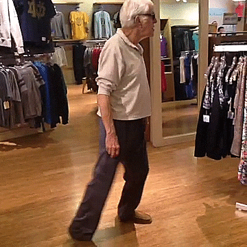 Celebrity gif. In a clothing store, Dick Van Dyke wearing sunglasses dances groovily. He doesn't care who's watching, he needs to groove!