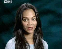 Celebrity gif. Zoe Saldana smiles and closes her eyes as she claps delicately.