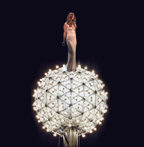 Celebrity gif. Lana Del Rey wears a fishtail gown as she twirls gracefully atop the Times Square New Year's Eve Ball.