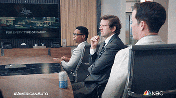 TV gif. Jon Barinholtz as Wesley, Tye White as Jack, and Humphrey Ker as Elliot in American Auto. They're sitting in a board room and they all turn to look at us at the same time, with eyebrows raised.