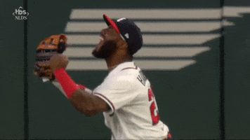 Sports gif. Slow motion gif of Michael Harris of the Atlanta Braves jumping up and screaming at the top of his lungs from the outfield like joy is bursting out of him.