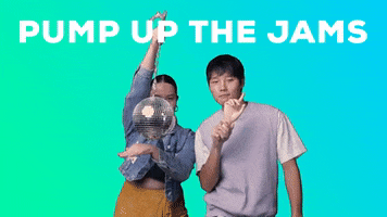Video gif. Young man and woman dance in front of a blue-green gradient background, one dangling and swatting at a disco ball and the other holding a mannequin hand with an index finger pointing up, both with silly, light-hearted expressions. Text, "Pump up the jams."