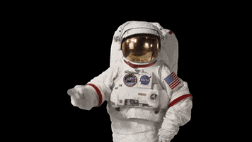 Video gif. Astronaut in full gear leans to the side, pointing a finger to the temple slowly in a gesture of wisdom.