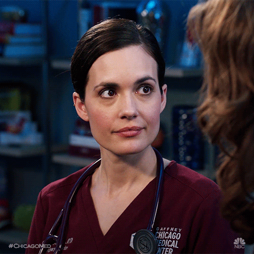 TV gif. Torrey DeVitto as Dr. Natalie from Chicago Med. She stares at the person she's talking to with wide eyes and tilts her head in an intrigued manner.