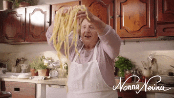 Video gif. Influencer Nonna Nerina holds up two handfuls of homemade pasta.