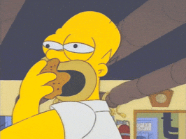 The Simpsons gif. Homer Simpson shovels donuts into his mouth with a blank stare while at work.