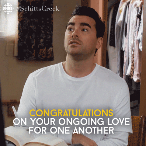 Schitt's Creek gif. Character David of Schitt's Creek sarcastically says "Congratulations on your ongoing love for one another. You did it!"