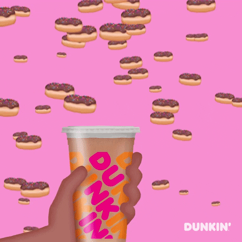 Ad gif. A cartoon hand holds a Dunkin' Donuts cup as chocolate donuts with sprinkles fall from the sky. The hand catches three donuts on top of the cup. Text, "National Donut Day."
