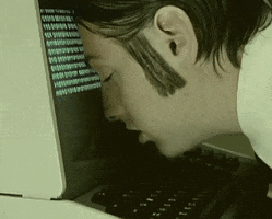 Music video gif. A man in the music video for "The Golden Path" by The Chemical Brothers has his head leaning on a computer and he looks totally destroyed and tired. 
