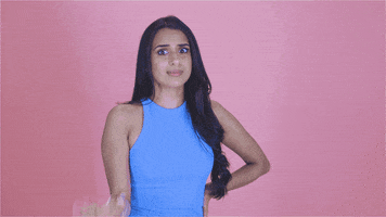Video gif. TV personality Monica Vaswani in a high rising, light blue dress stops us with her hand and wags her index finger. She stares at us as if warning us to not make the same mistake.