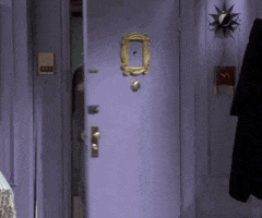 Friends gif. Matt Leblanc as Joey stomps excitedly into an apartment as he points and claps cheerfully as if in celebration towards his friends. 