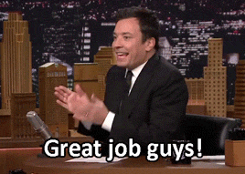 Tonight Show gif. Jimmy Fallon rubs his hands together as he shakes giddy in his seat. He fumbles to get his thumbs up as he says, “Great job guys!”