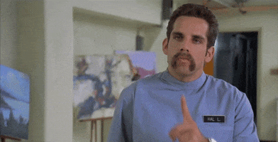 Movie gif. Ben Stiller as Hal in Happy Gilmore brings his index finger to his mouth and across his neck in a threatening, silencing gesture. 