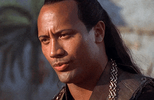 Movie gif. Dwayne Johnson as Mathayus in The Scorpion King has long black hair pulled back. His eyebrows raise, as he slowly nods his head with a calm and confident expression. A wide smile sweeps across his face. 
