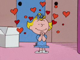 Peanuts gif. Sally Brown stands with her hands clasped together, looking deeply enamored. Hearts swell around her, popping, bursting, and reforming as she exudes love. 